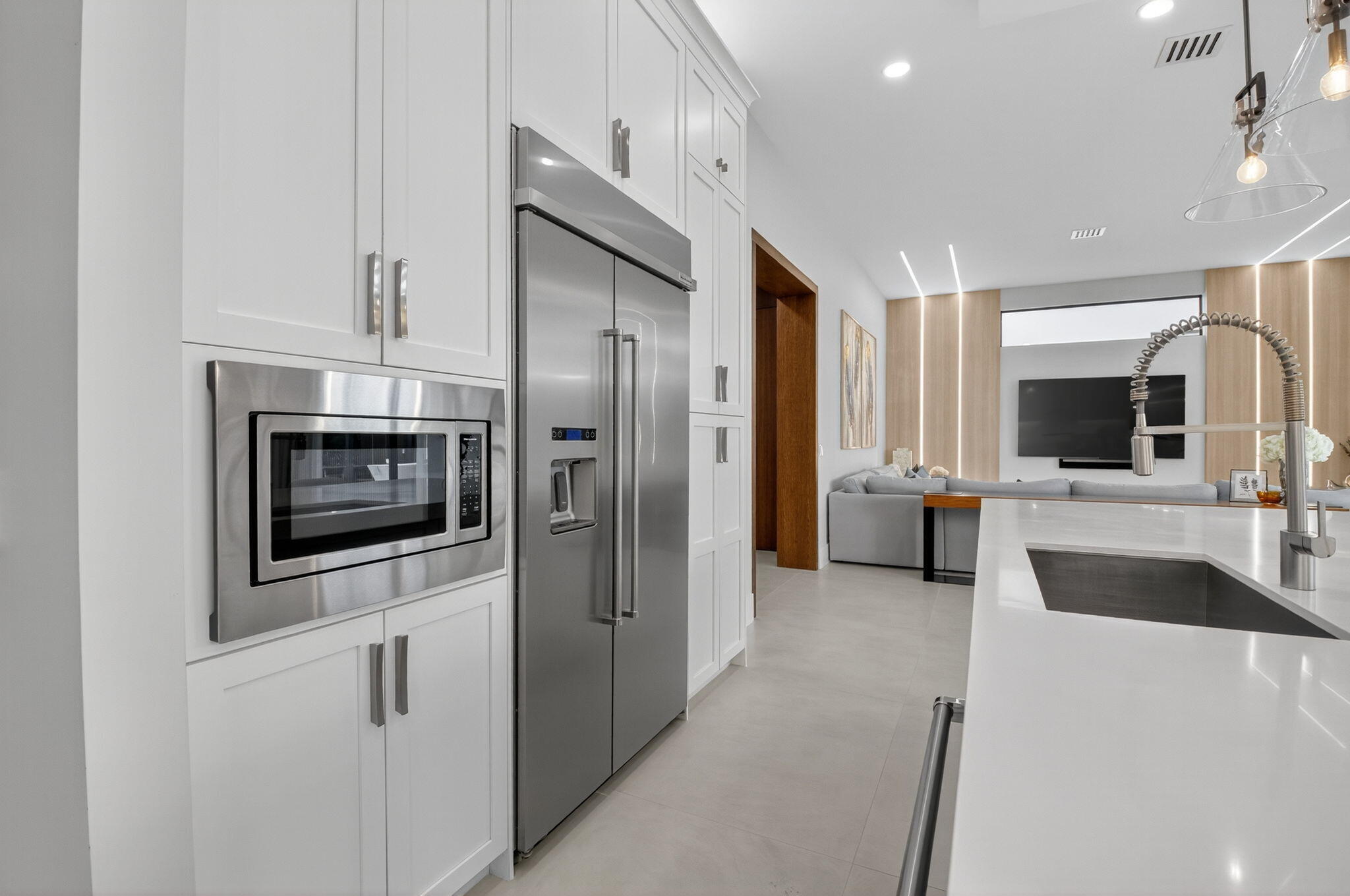 9083 Benedetta Place Boca Raton, FL 33496 - Photo 27 of 112 a kitchen with stainless steel appliances a refrigerator a microwave a stove and white cabinets