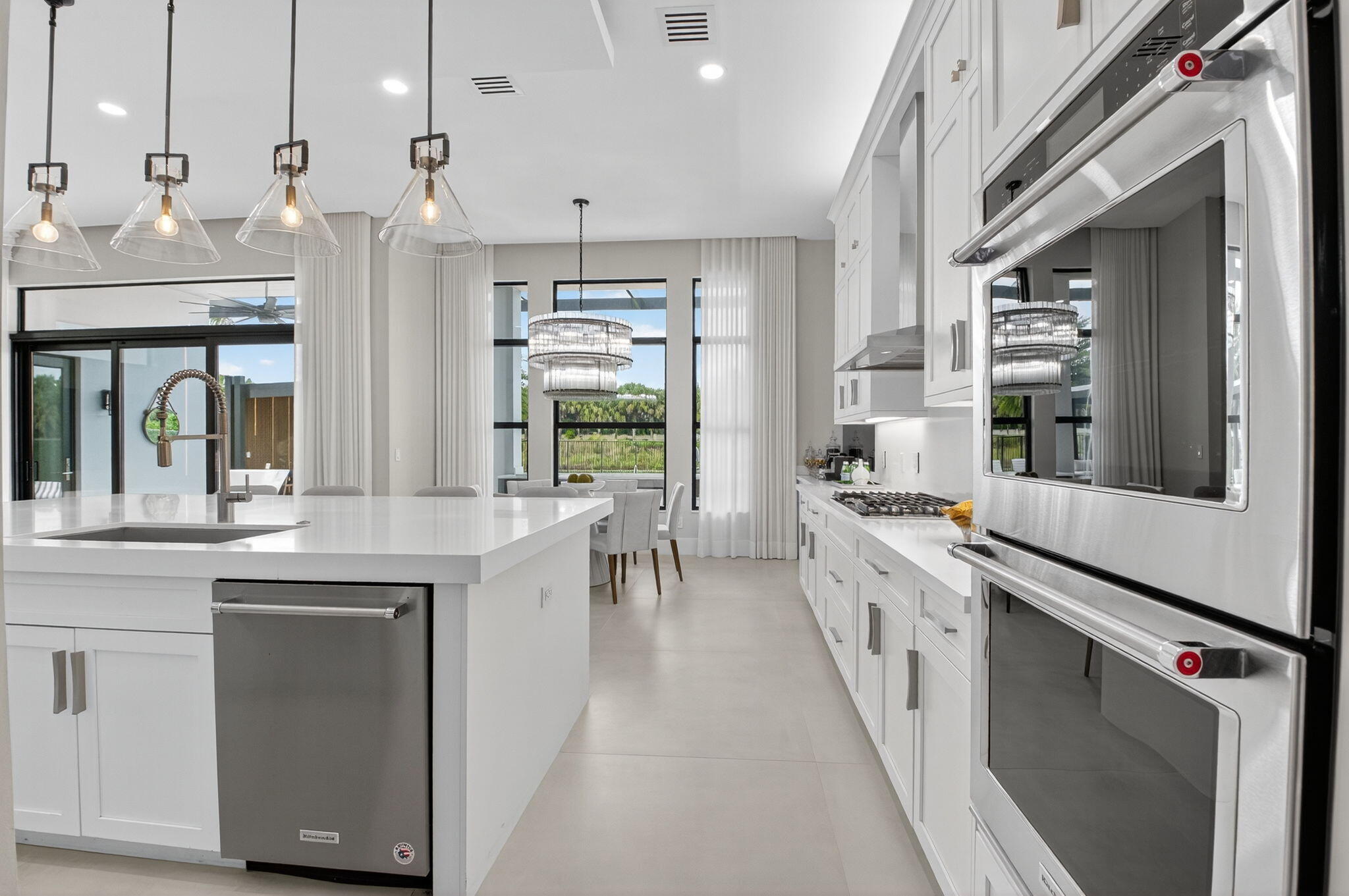 9083 Benedetta Place Boca Raton, FL 33496 - Photo 28 of 112 a kitchen with stainless steel appliances granite countertop a lot of counter space and wooden floors