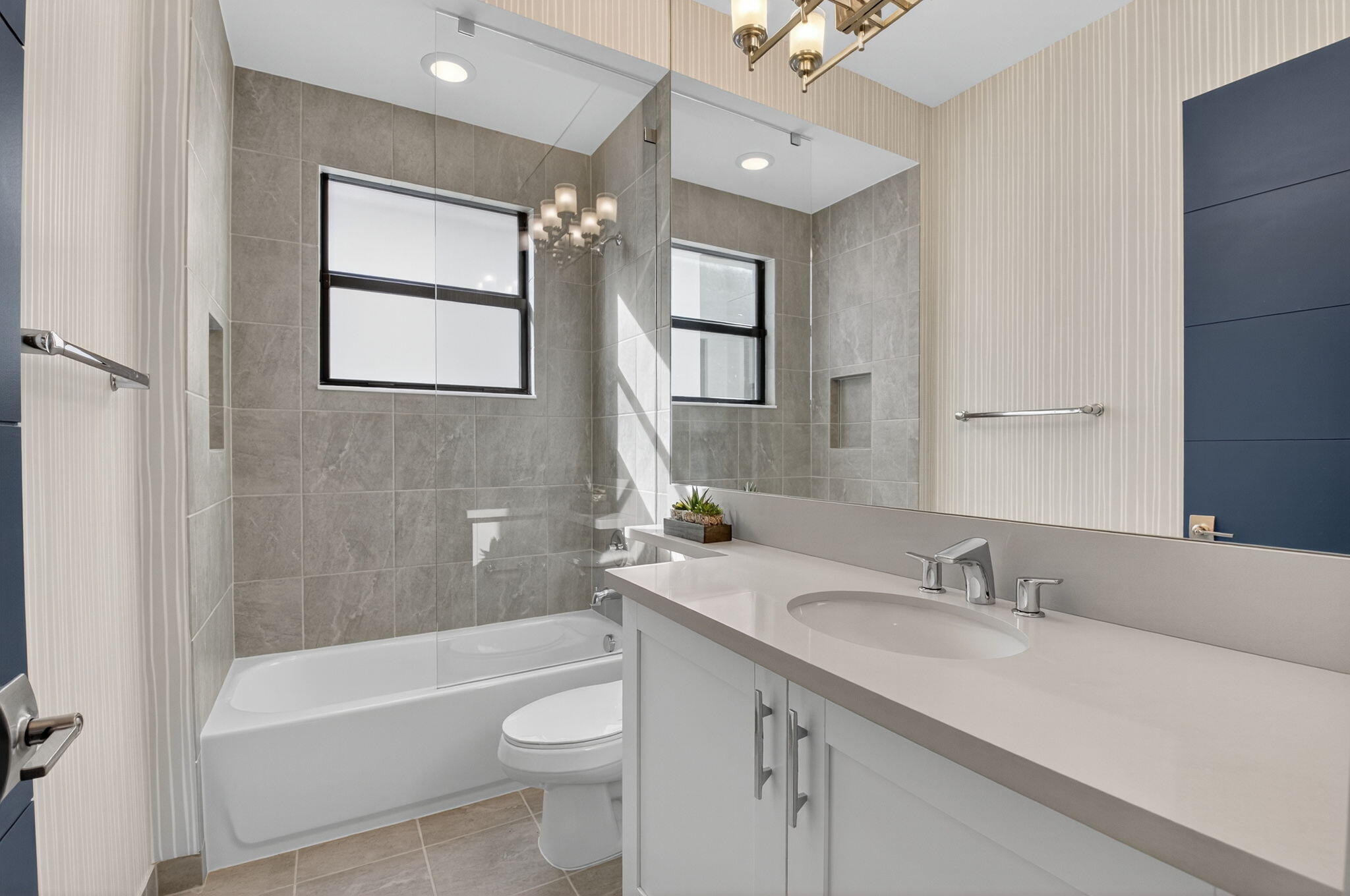 9083 Benedetta Place Boca Raton, FL 33496 - Photo 52 of 112 a bathroom with a granite countertop sink a toilet a mirror a bathtub and shower