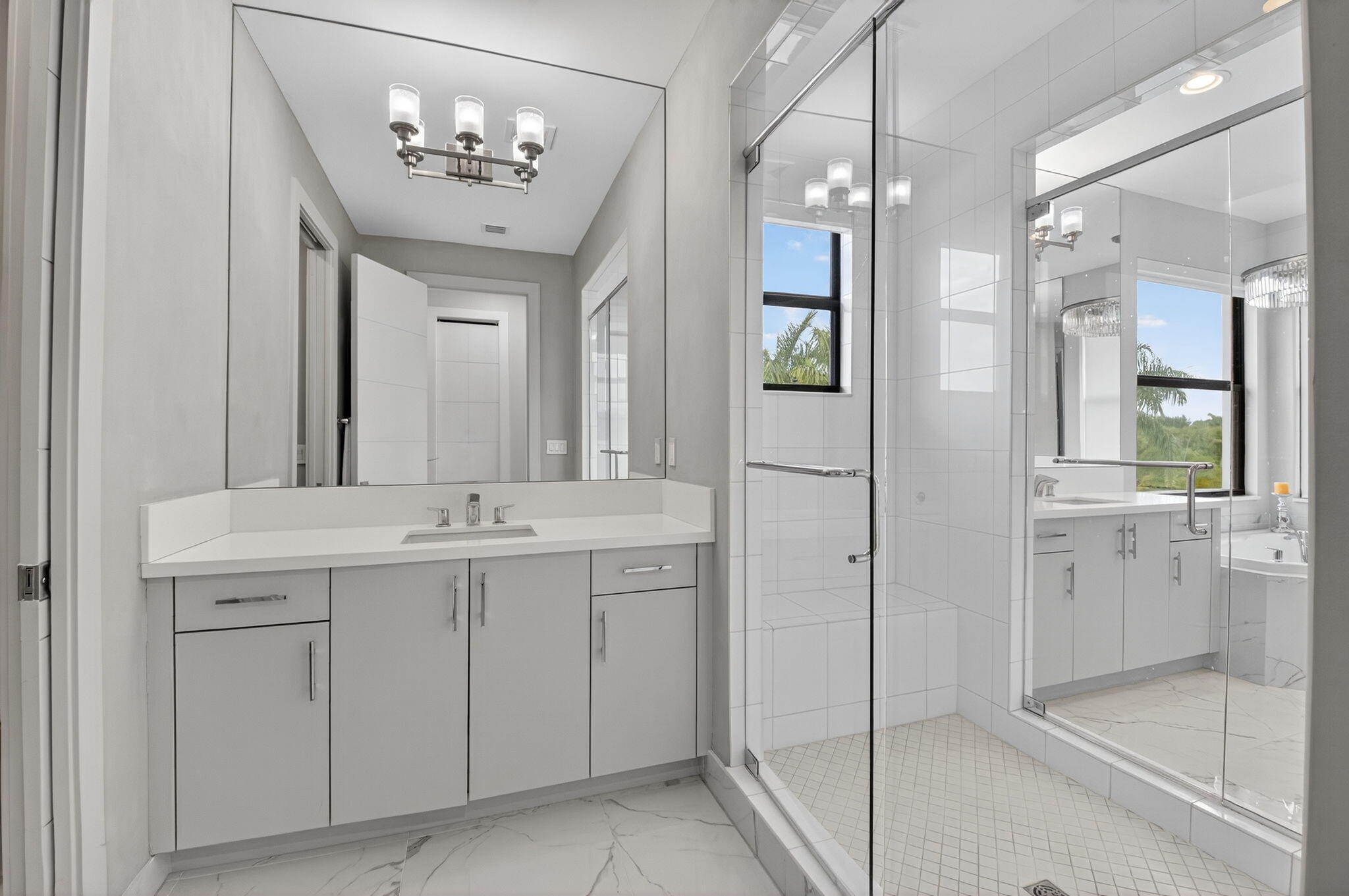 9083 Benedetta Place Boca Raton, FL 33496 - Photo 53 of 112 a spacious bathroom with a granite countertop sink a mirror and a shower