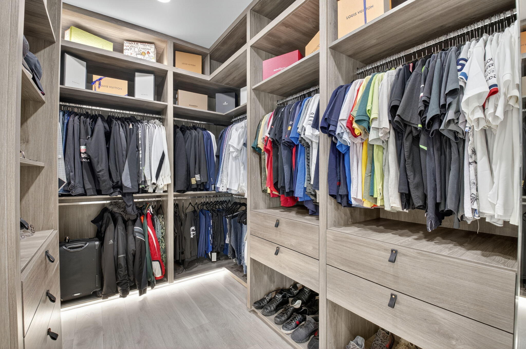 9083 Benedetta Place Boca Raton, FL 33496 - Photo 56 of 112 a view of walk in closet with clothes and shoes