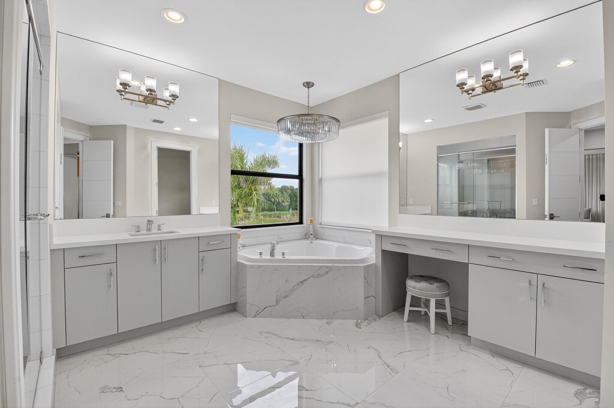9083 Benedetta Place Boca Raton, FL 33496 - Photo 58 of 112 a spacious bathroom with a granite countertop sink a large mirror and a bathtub