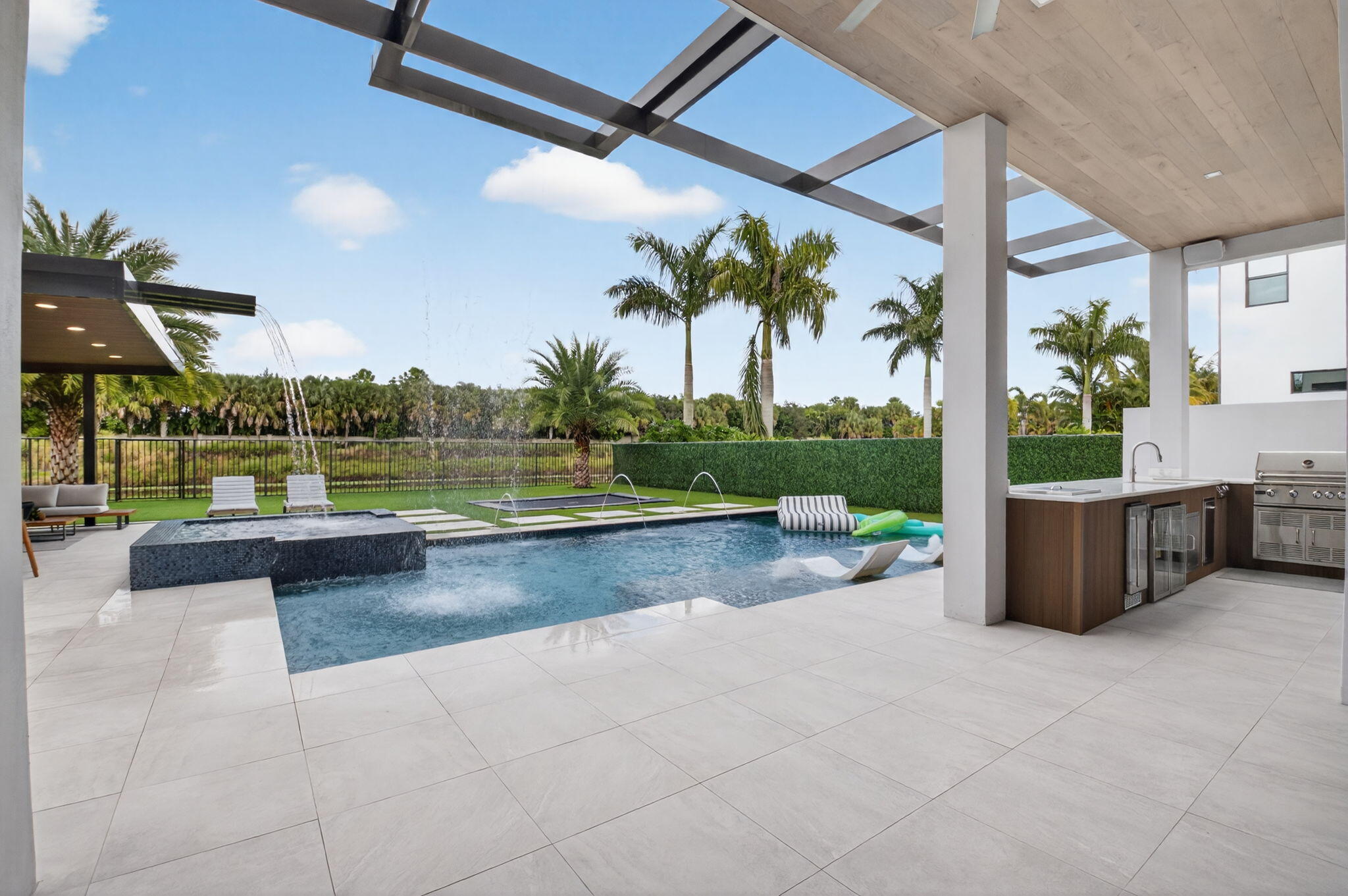 9083 Benedetta Place Boca Raton, FL 33496 - Photo 62 of 112 a view of a swimming pool with a patio and a garden