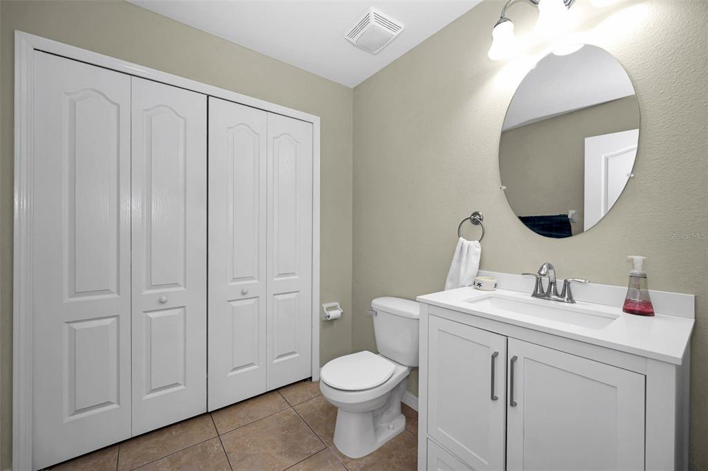 9736 Trumpet Vine Loop Trinity, FL 34655 - Photo 9 of 35 a bathroom with a toilet a sink and mirror