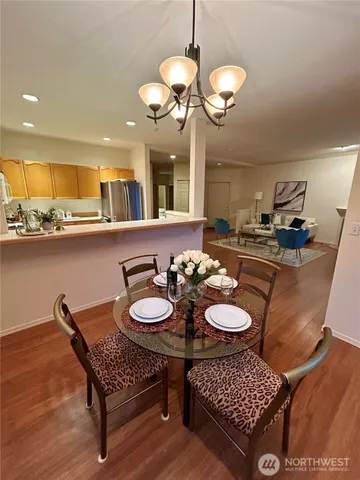 a view of a dining room with furniture and chandelier
