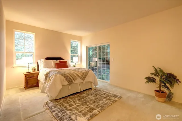 a bedroom with a large bed and a window