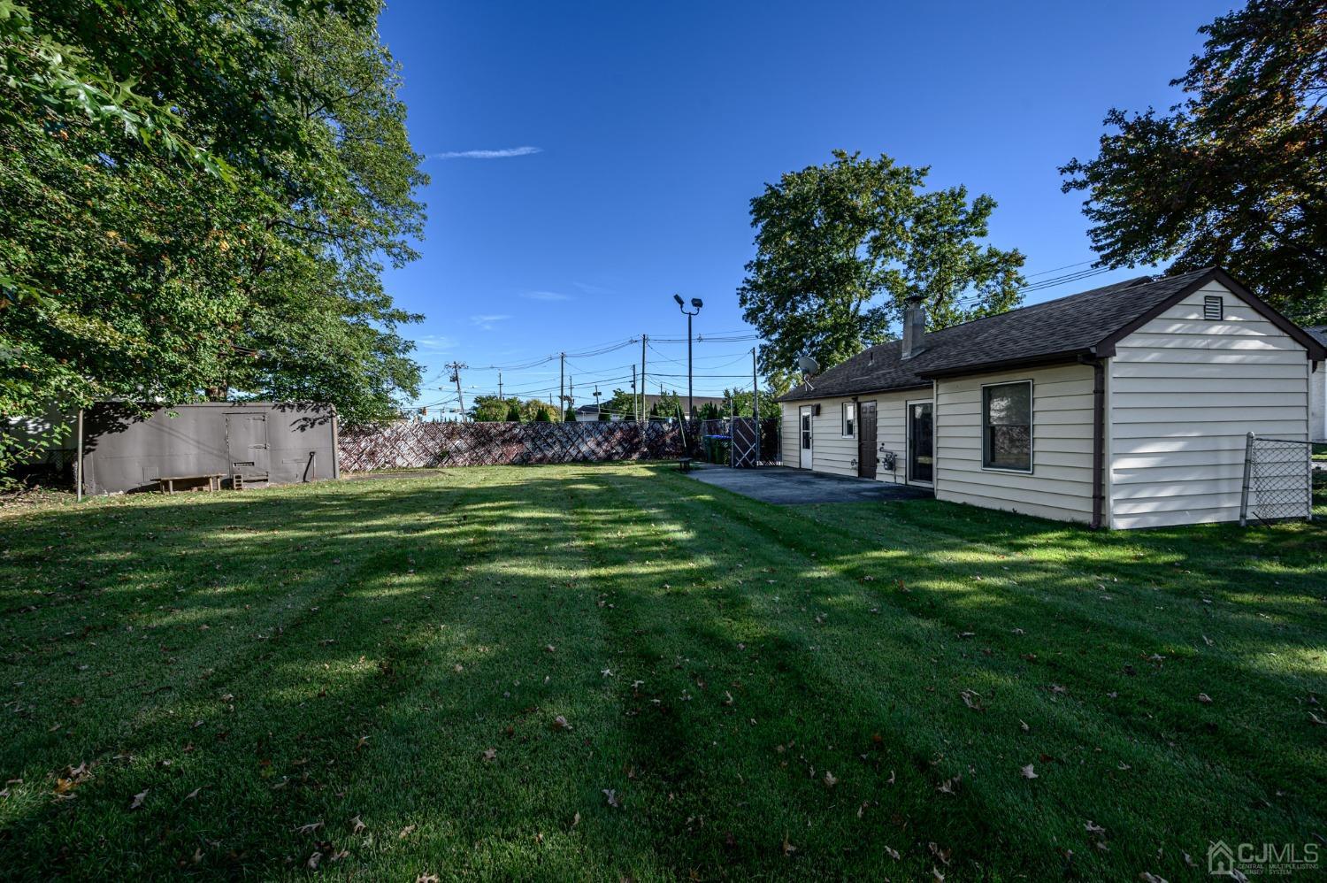 15 Johnstone Street Edison, NJ 08817 - Photo 20 of 28 a view of a backyard with plants and large trees