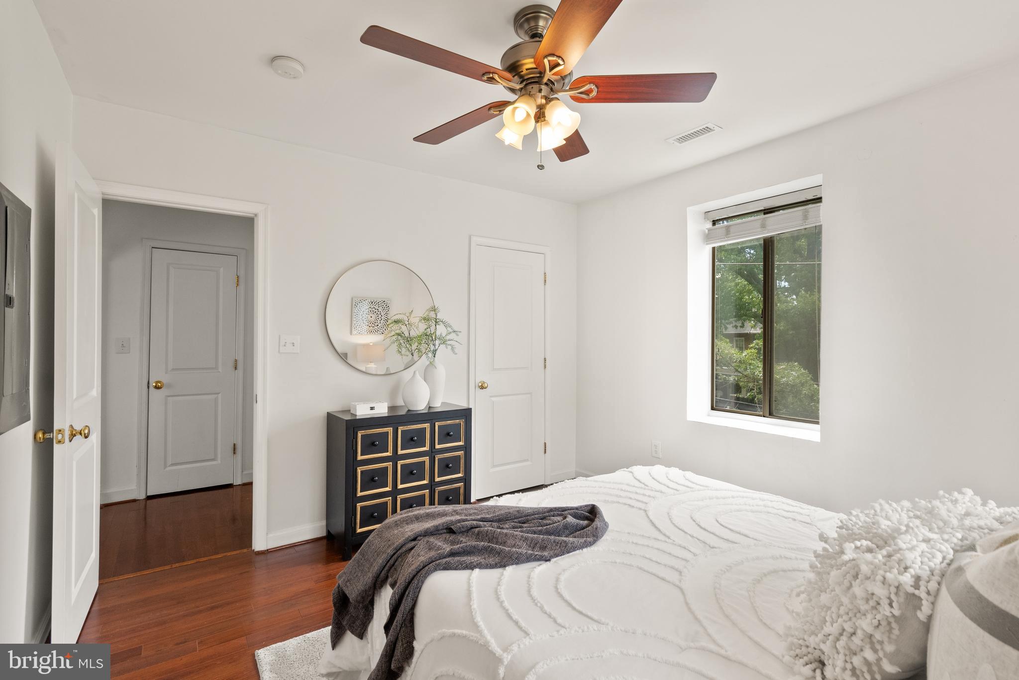 5401 9th Street Northwest, Unit 201 Washington, DC 20011 - Photo 13 of 19 a bedroom with a bed a chandelier and a window