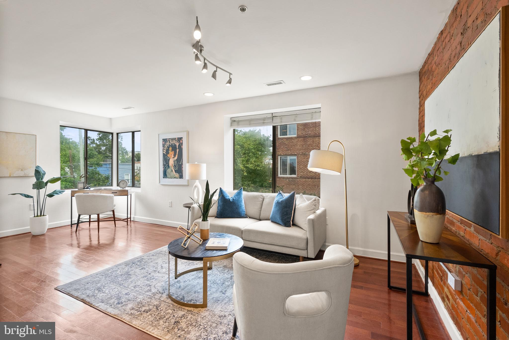 5401 9th Street Northwest, Unit 201 Washington, DC 20011 - Photo 2 of 19 a living room with furniture large window and wooden floor
