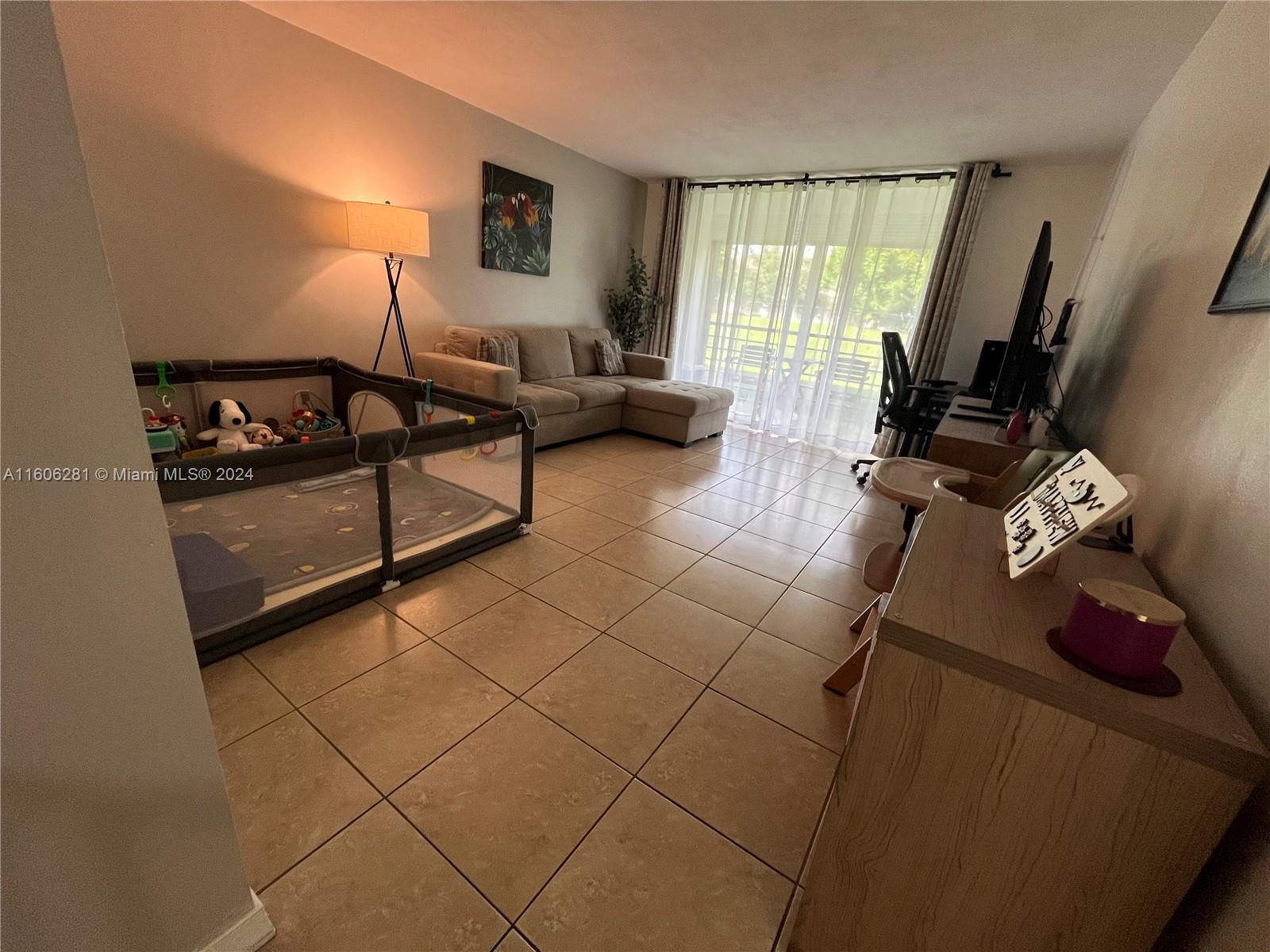 3490 Foxcroft Road, Unit B107 Miramar, FL 33025 - Photo 13 of 32 a bedroom with furniture and a window