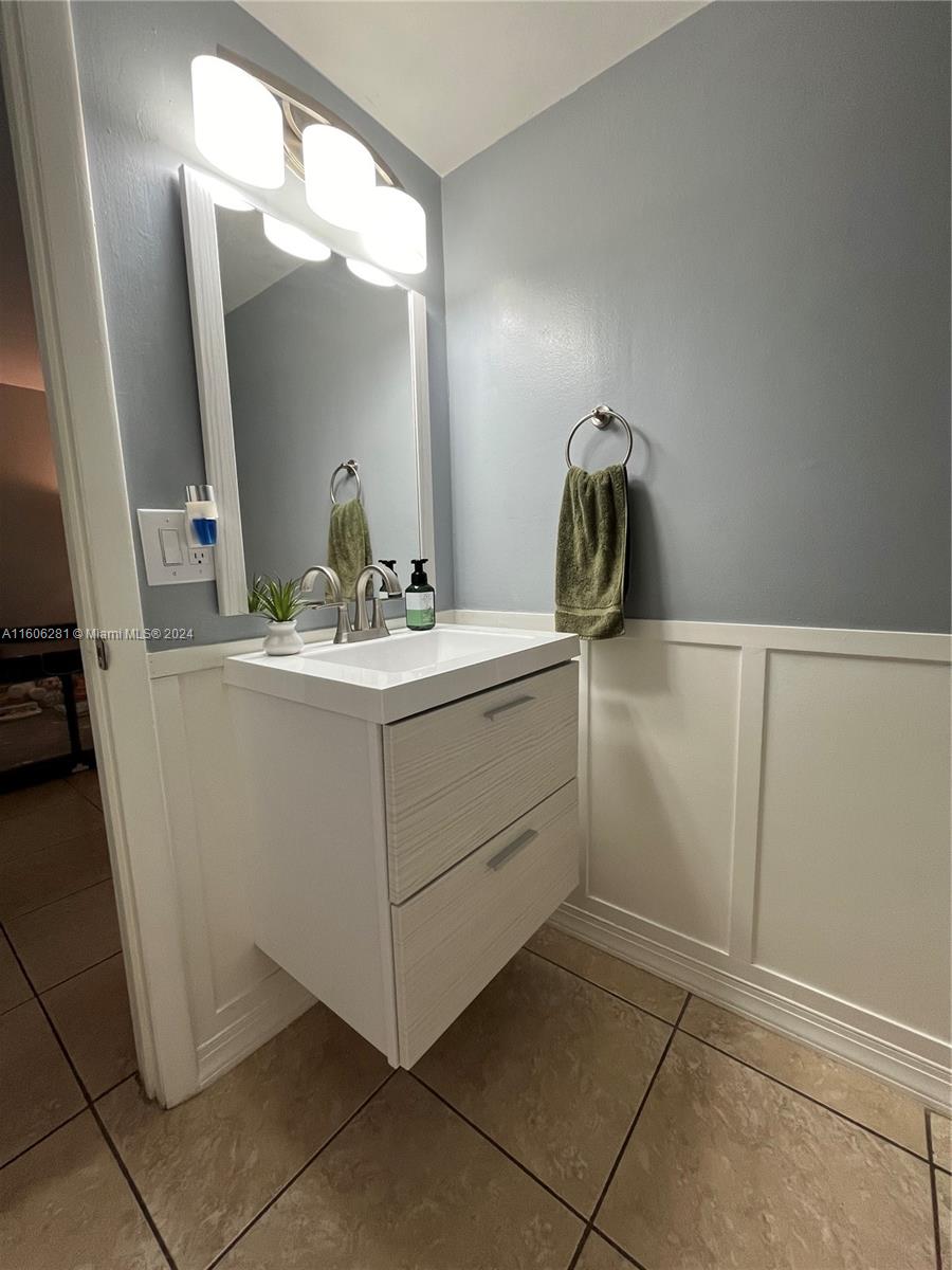 3490 Foxcroft Road, Unit B107 Miramar, FL 33025 - Photo 16 of 32 a bathroom with a sink and a mirror