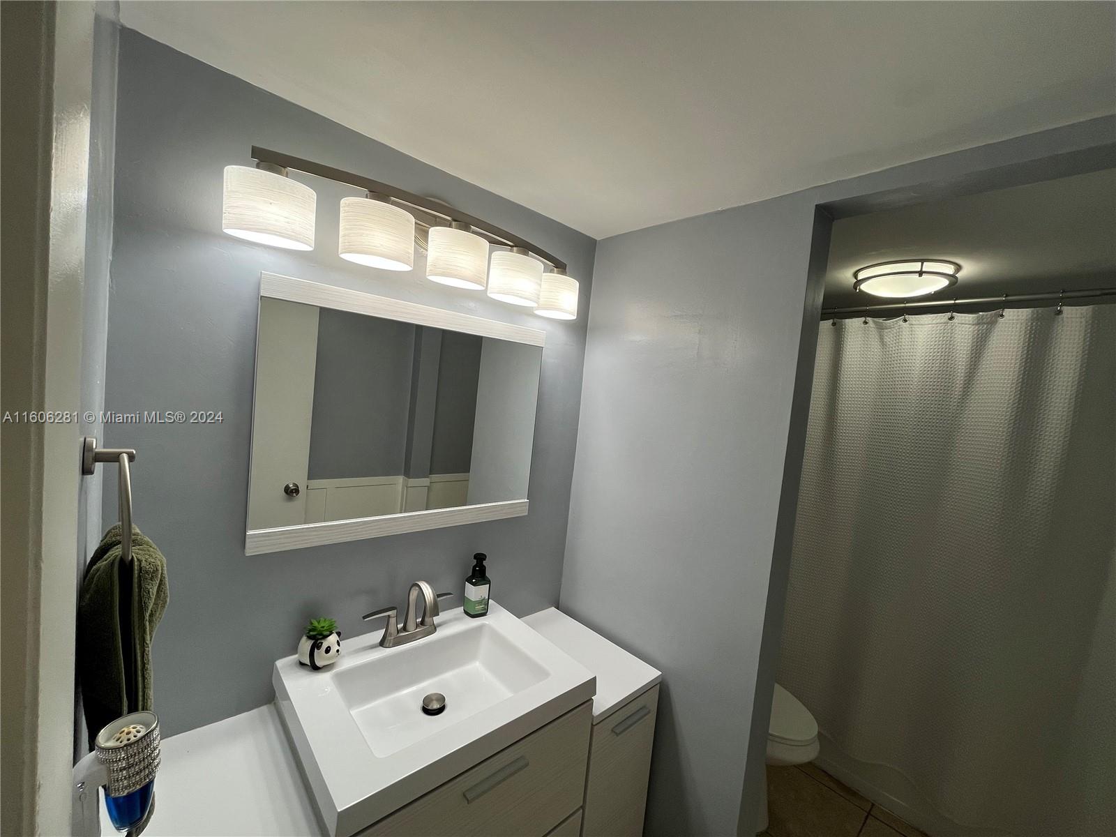 3490 Foxcroft Road, Unit B107 Miramar, FL 33025 - Photo 20 of 32 a bathroom with a sink mirror and vanity