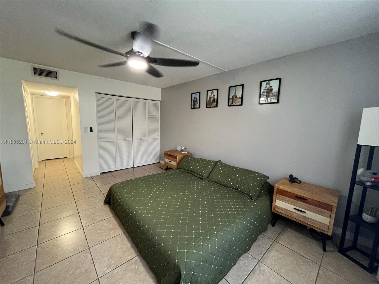 3490 Foxcroft Road, Unit B107 Miramar, FL 33025 - Photo 26 of 32 a bedroom with a bed and a chandelier