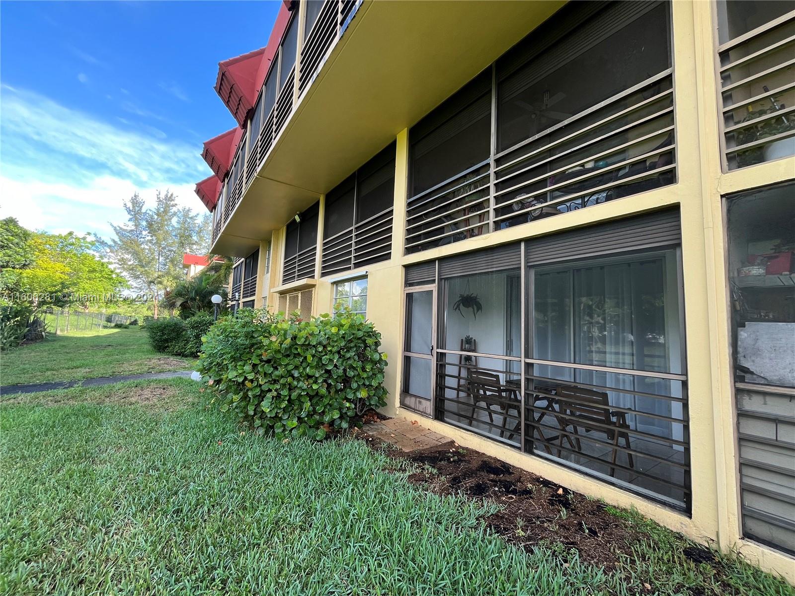 3490 Foxcroft Road, Unit B107 Miramar, FL 33025 - Photo 29 of 32 a backyard of a house with lots of green space