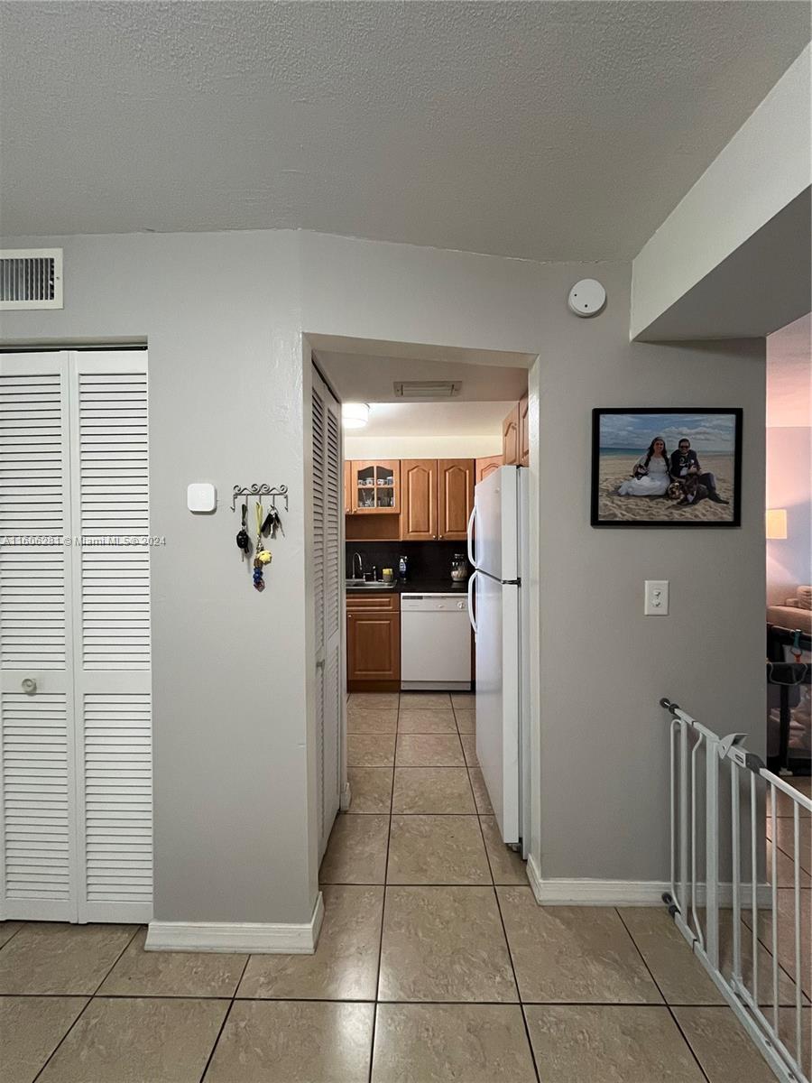 3490 Foxcroft Road, Unit B107 Miramar, FL 33025 - Photo 10 of 32 a view of a hallway with a kitchen