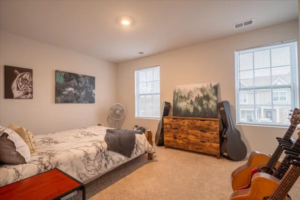 a bedroom with furniture and a window