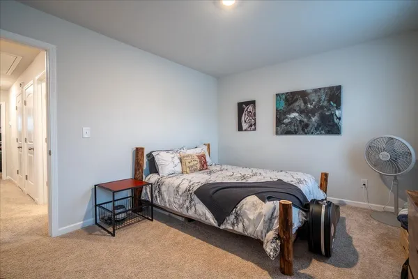 a bedroom that has a bed and a chair in it