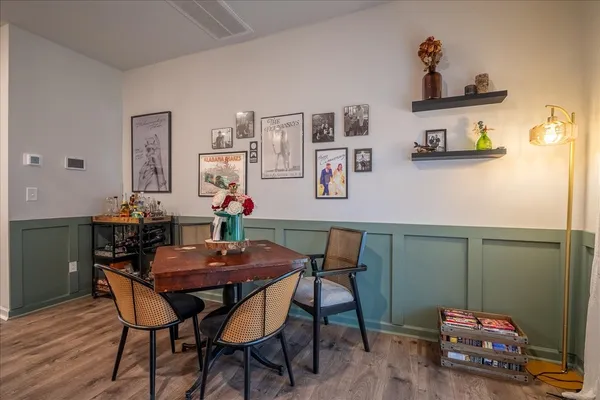 a view of a dining room with furniture and wooden floor