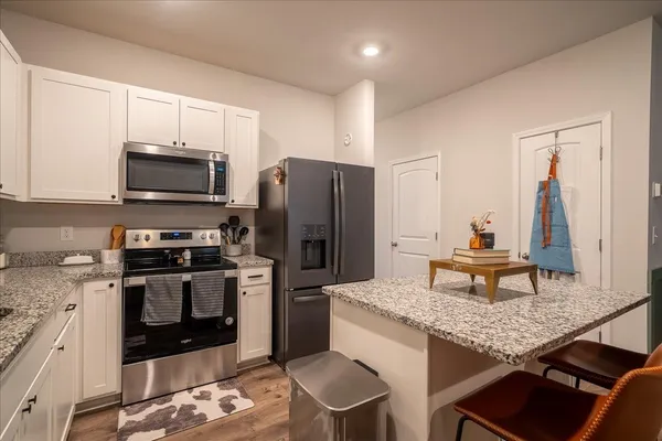 a kitchen with a stove a microwave and refrigerator