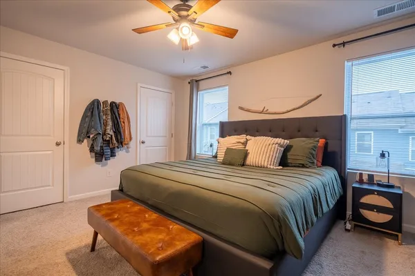 a bedroom with a bed and window