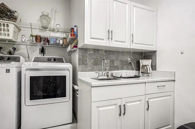 a kitchen with cabinets and white stainless steel appliances