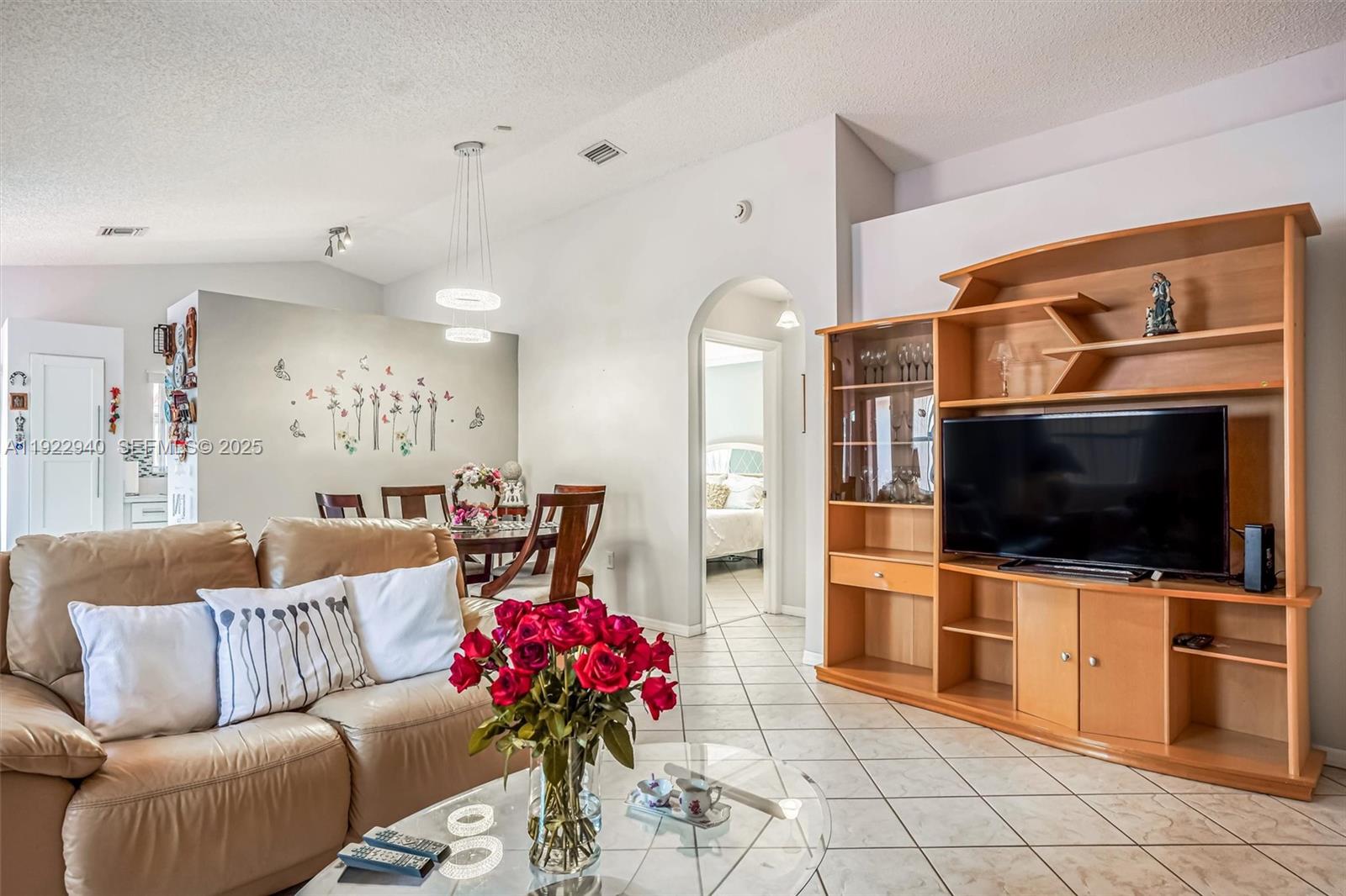 14117 Southwest 149th Avenue Miami, FL 33196 - Photo 14 of 32 a living room with furniture and a flat screen tv