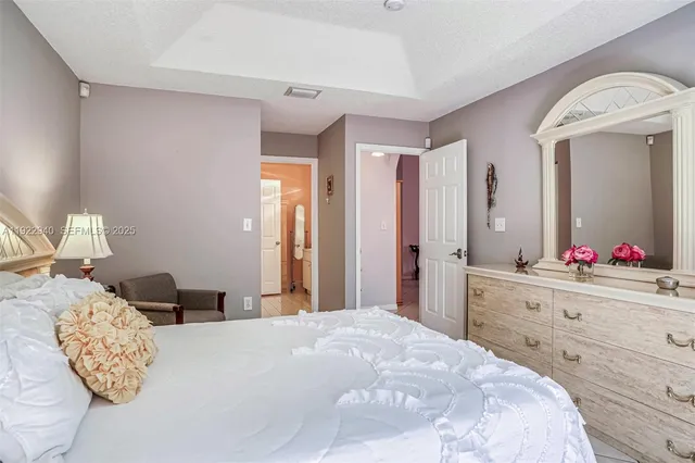 a bedroom with a large bed and a dresser