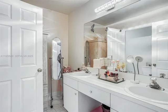 a bathroom with a double vanity sink and a mirror