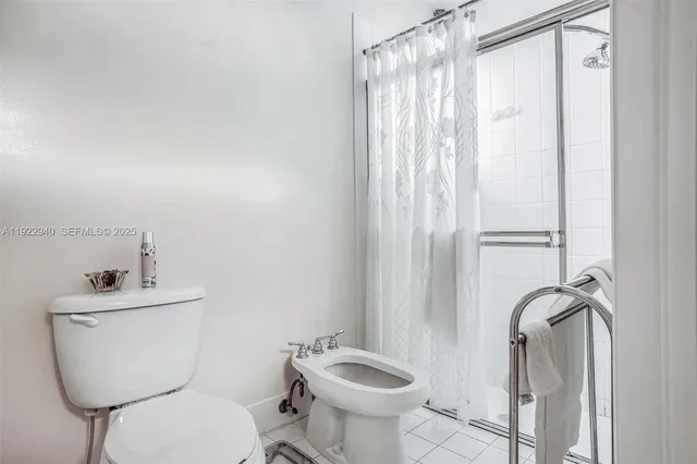 a bathroom with a toilet sink and shower