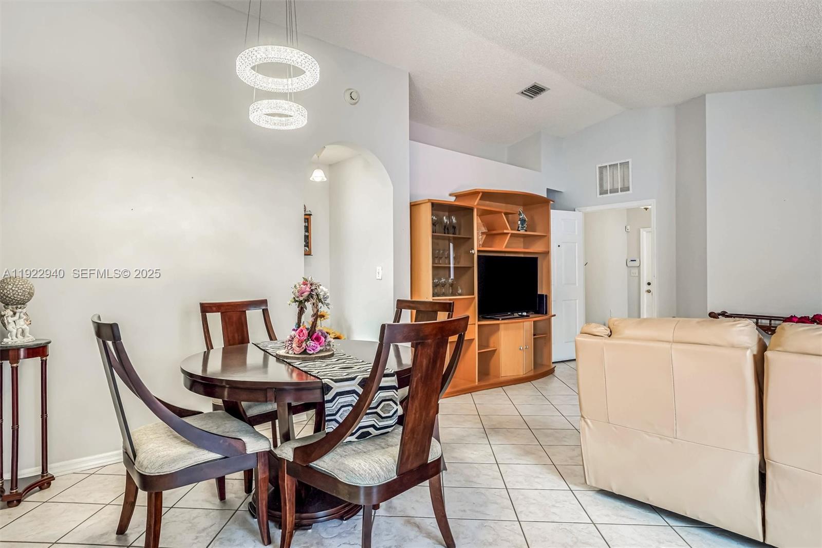 14117 Southwest 149th Avenue Miami, FL 33196 - Photo 22 of 32 a view of a dining room with furniture and chandelier