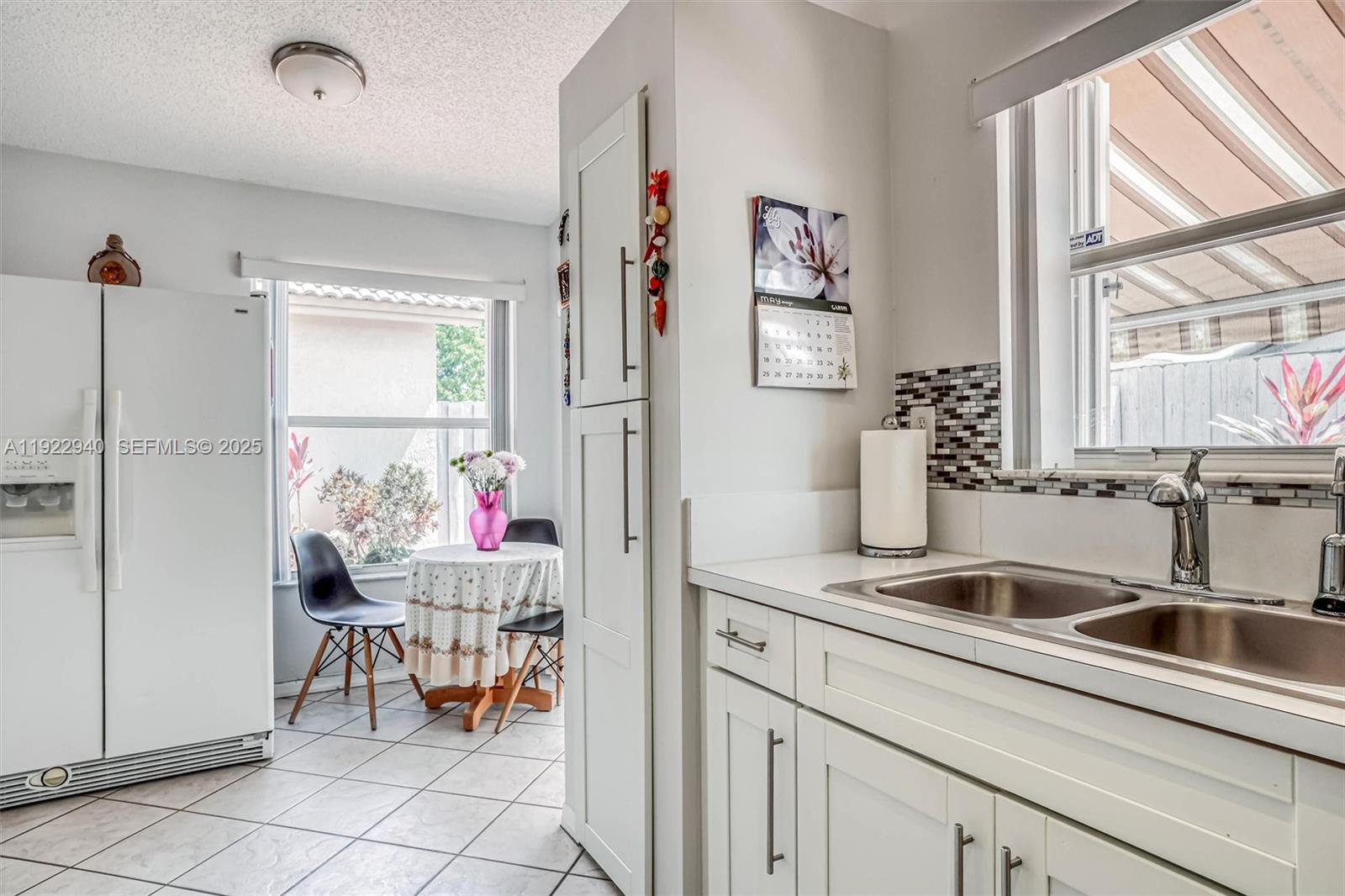 14117 Southwest 149th Avenue Miami, FL 33196 - Photo 25 of 32 a kitchen with a sink and a refrigerator