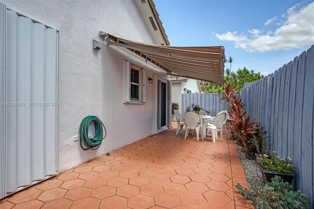 a backyard of a house with table and chairs
