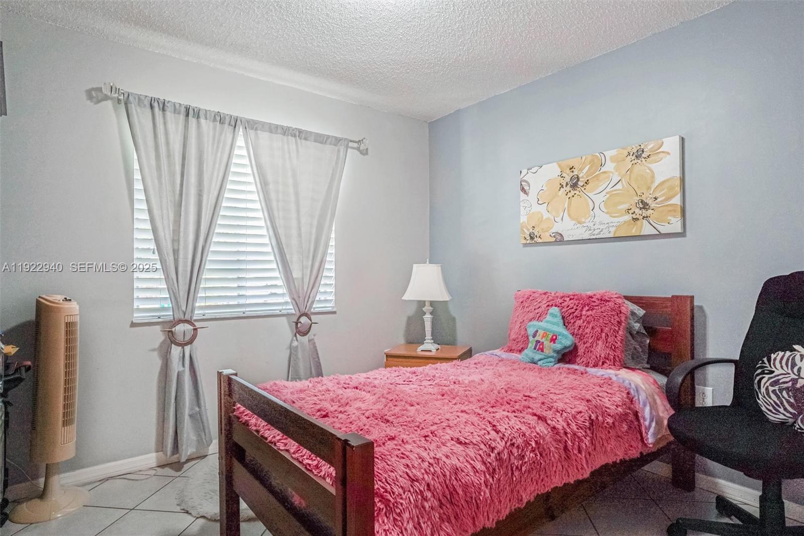 14117 Southwest 149th Avenue Miami, FL 33196 - Photo 4 of 32 a bedroom with a bed and a window