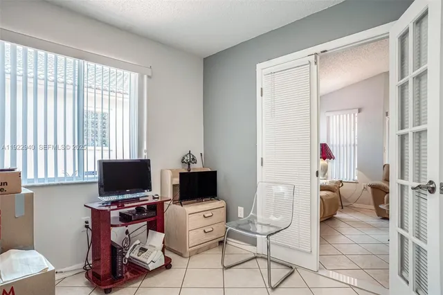 a view of a livingroom with workspace and a window