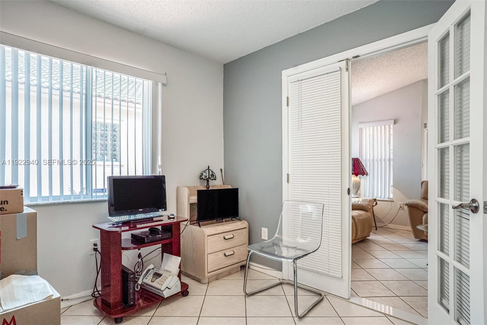 14117 Southwest 149th Avenue Miami, FL 33196 - Photo 7 of 32 a view of a livingroom with workspace and a window