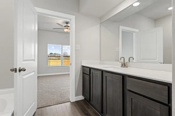 a bathroom with a sink a light fixture and a mirror