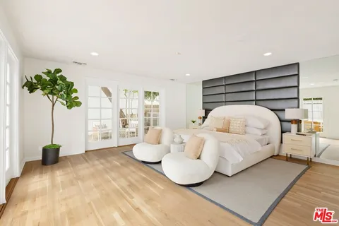 a bedroom with a bed and a potted plant