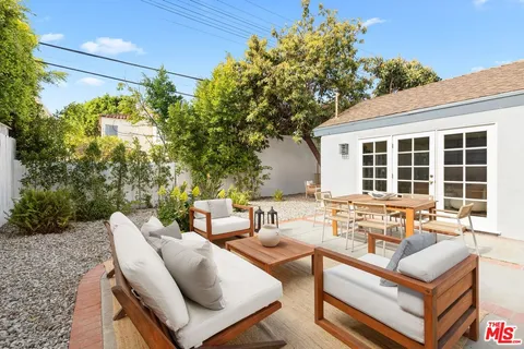 a view of a patio with couches and potted plants