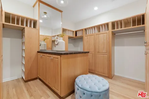a view of a hallway with entryway wooden floor and front door