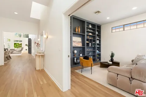 a living room with furniture and a book shelf