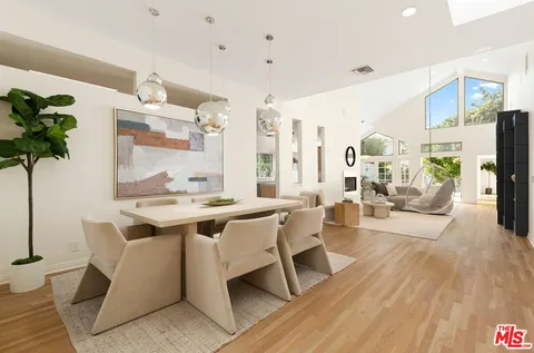 a view of a kitchen area with furniture and wooden floor