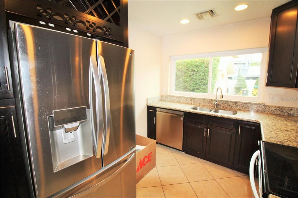 1609 Tulane Street Orlando, FL 32804 - Photo 2 of 21 a kitchen with stainless steel appliances granite countertop a refrigerator and a sink