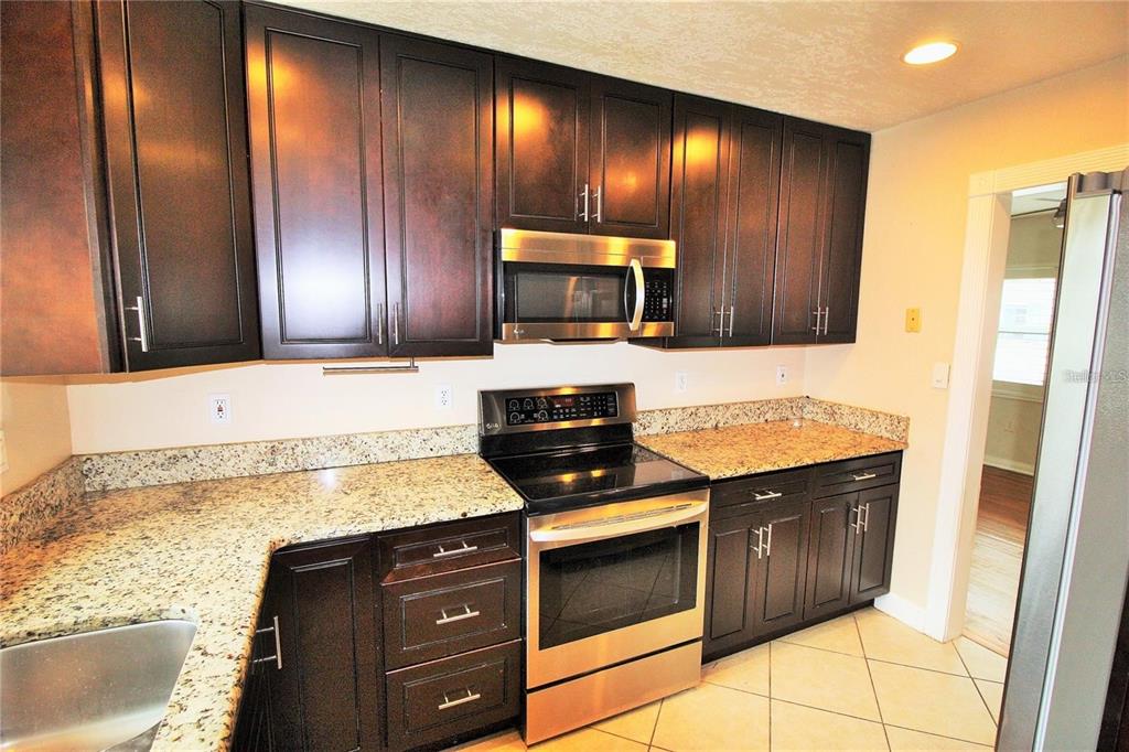 1609 Tulane Street Orlando, FL 32804 - Photo 4 of 21 a kitchen with granite countertop stainless steel appliances and cabinets