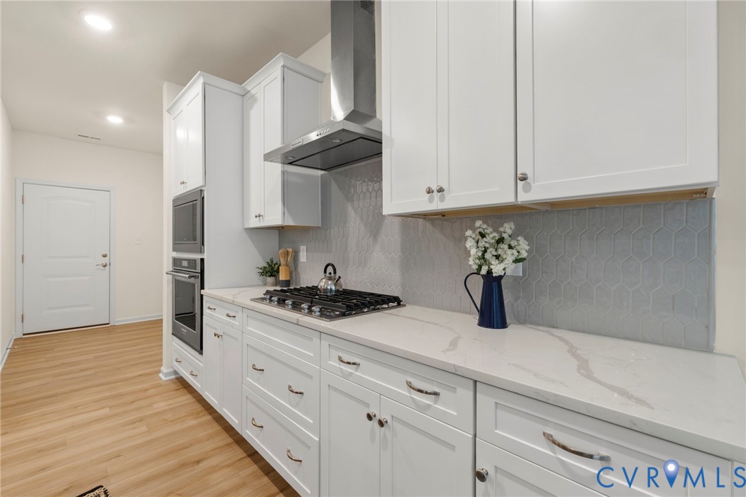 4236 Shirley Road Richmond, VA 23225 - Photo 16 of 40 a kitchen with stainless steel appliances granite countertop a sink a stove and a refrigerator