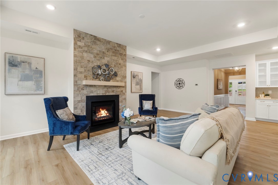 4236 Shirley Road Richmond, VA 23225 - Photo 20 of 40 a living room with furniture a fireplace and a table