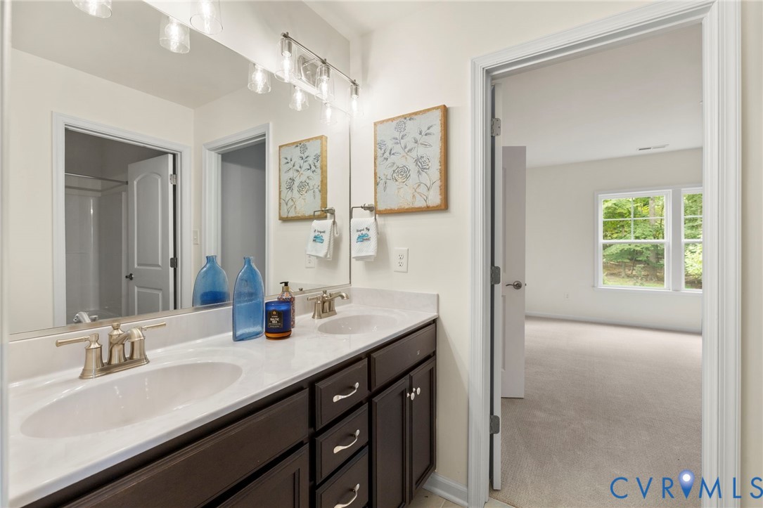 4236 Shirley Road Richmond, VA 23225 - Photo 34 of 40 a bathroom with a sink double vanity and a mirror