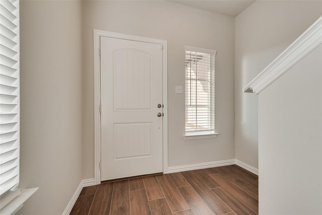 225 Sutter Mill Road Saginaw, TX 76131 - Photo 7 of 24 an empty room with wooden floor and windows