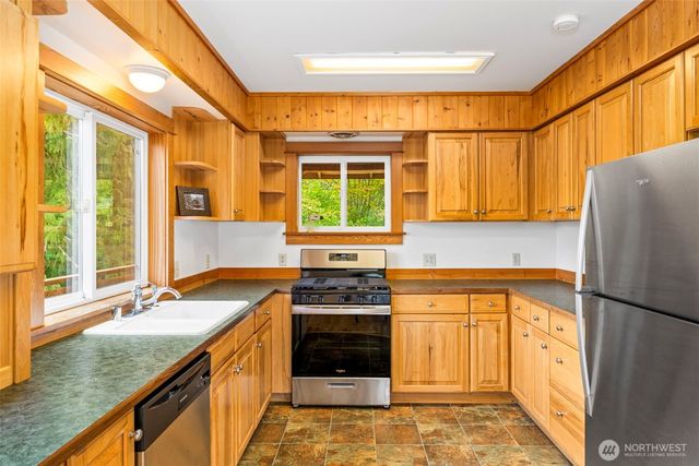 a kitchen that has a sink and a stove