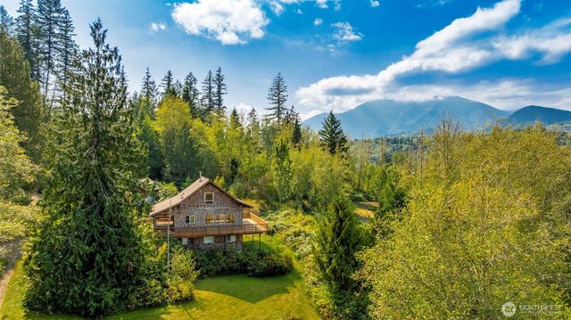 a view of a room that has a large window and front door