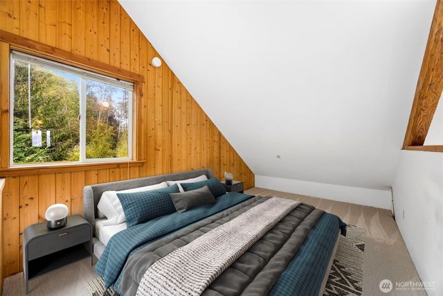 a balcony with wooden floor and outdoor seating